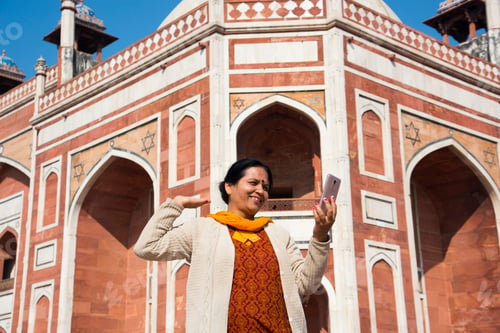 Preview: Indian woman taking selfie with smartphone in front of Humayun's Tomb