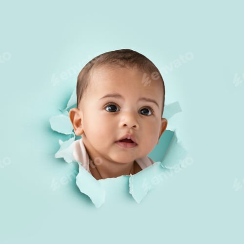Preview: Serious cute spanish or arabic little kid looking through hole on light paper