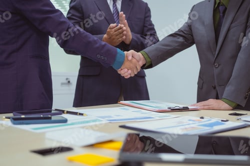 Preview: Close-up of business people shaking hands during meeting in the office,discussing analyzing charts