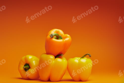 Preview: close-up view of fresh organic bell peppers on orange