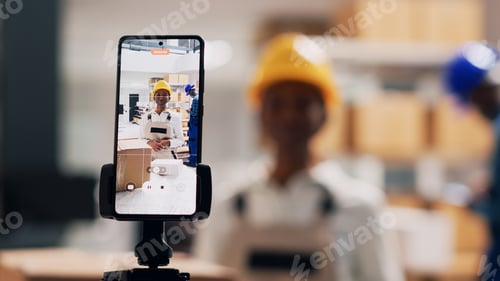 Preview: Female employee in overalls recording online video