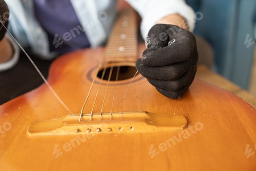 Preview: the technician setting up the guitar in the workshop