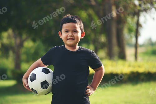 Preview: Little boy hand holding soccer football