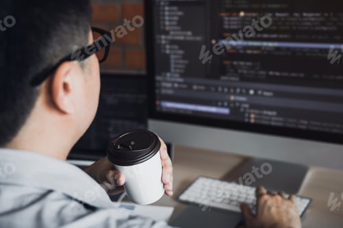 Preview: In the morning of work with a program developer holding a coffee at the office