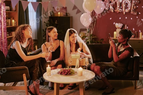 Preview: Multiethnic Young Adult Women Smiling and Taking Photos during Bachelorette Party