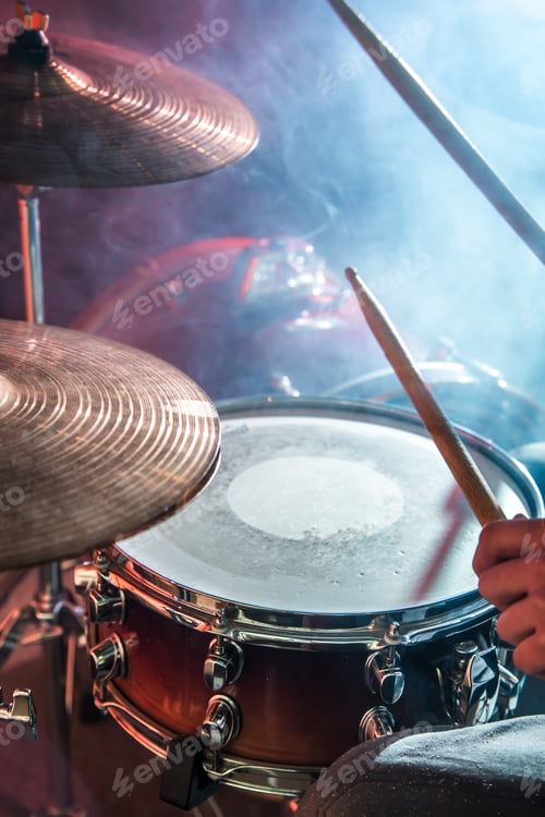 Preview: man plays the drum, flash of light, a beautiful light in the background with copy space
