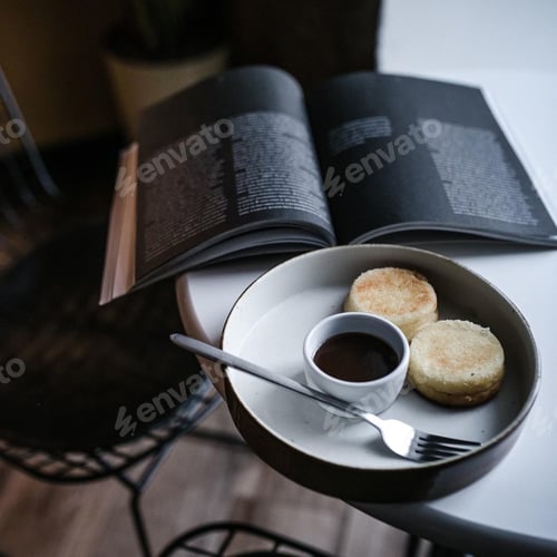 Stack of Scones with Dark Sauce and Book