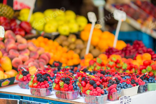 Preview: Berry fruits at a marketplace. Blueberries, raspberries, strawberries, cherries and blackberries on