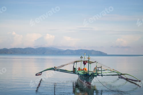 Preview: Beautiful shot of a reflective lake surface with a boat near the Barton port, Philippines
