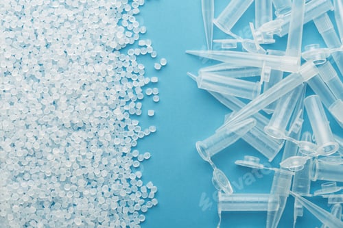 Preview: Plastic pellets meet pile of pipette tips and microtubes on blue background