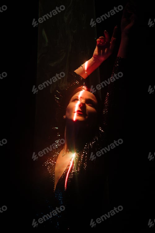 Preview: Beautiful woman dancing under colorful illumination, laser light, neon party night club
