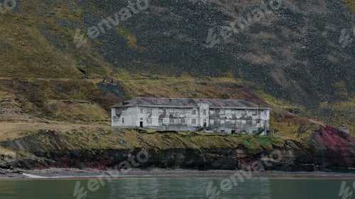 Preview: Abandoned building on the Svalbard coast in Grumant surrounded by steep mountains