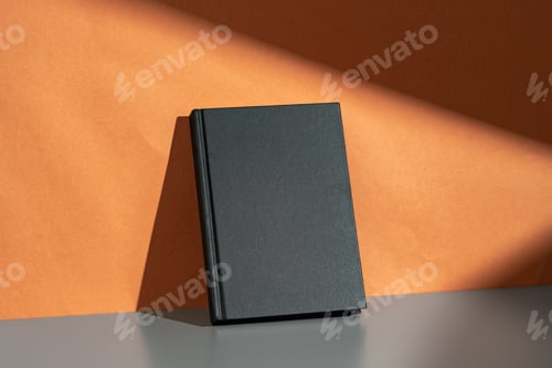 Preview: Black notepad mock up against terracotta wall