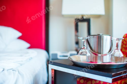 Preview: Romantic bedroom with wine glasses and ice bucket in luxury hotel interior