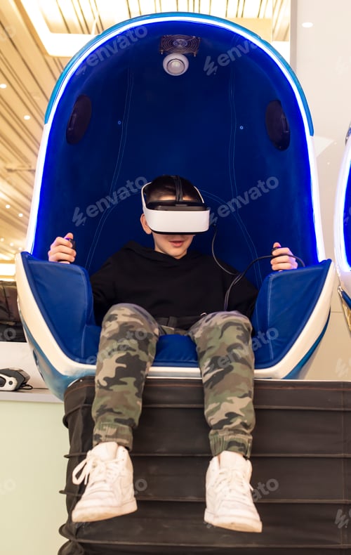 Preview: Child playing game with VR glasses. Technology, entertainment an