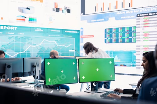 Preview: Executive officer analyzing green screen on monitors at his workstation