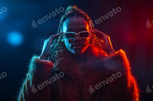 Preview: Black ethnic woman with braids with blue and red led lights, wearing a fur coat