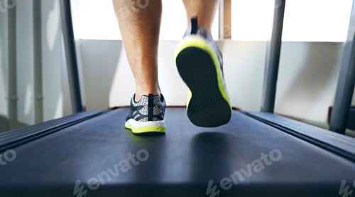 Preview: The long walk to fitness. Cropped shot of an unrecognizable man jogging on a treadmill in the gym.