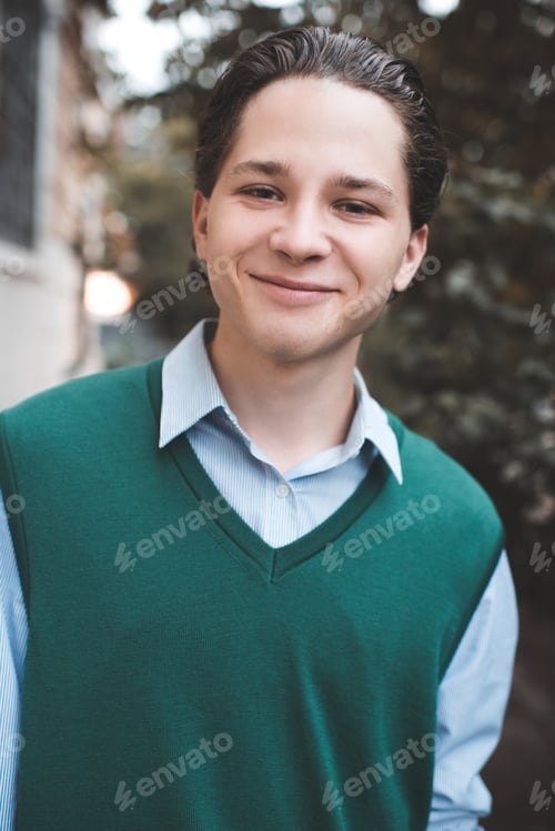 Preview: Happy teenage boy 17-18 year old with black long hair posing outdoors