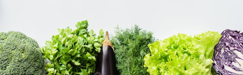 Preview: top view of greens, red cabbage and eggplant on white background, panoramic shot