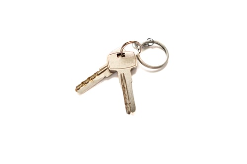 Preview: metal apartment key isolated on white background