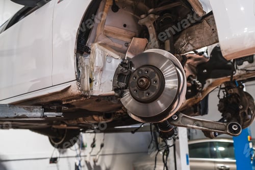 Preview: Car disk brake getting fixed on elevated vehicle in auto repair shop