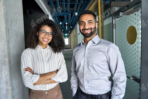 Preview: Two happy diverse professional business team people looking at camera in office.