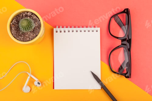 Preview: Writing tools on a colorful background with a cactus and glasses next to a blank notepad