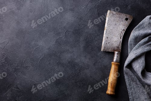 Preview: Meat Cleaver with Napkin on dark grey stone background. Copy space. Top view.