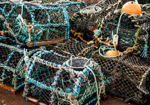 Preview: Pile of old crab traps and fishing nets stacked on one another