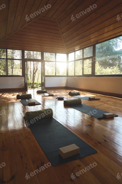Preview: Gym studio for yoga meditation background with mats on wooden floor. Vertical.