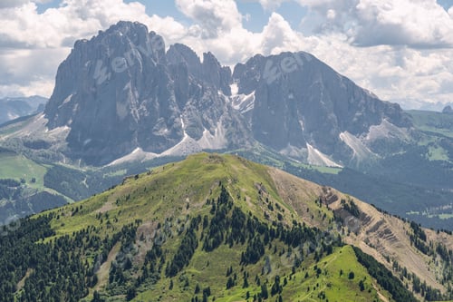 Preview: Idyllic landscape with green mountain hill under sky