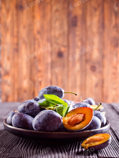 Preview: Ripe plum on dark wooden background
