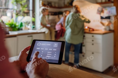 Preview: Man using smart thermostat, adjusting, lowering heating temperature at home. Concept of sustainable