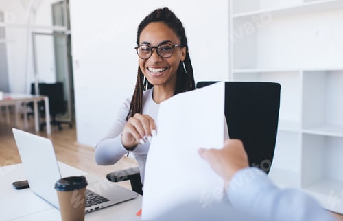 Preview: Joyful business woman giving documents for analyzing statistics in office interior