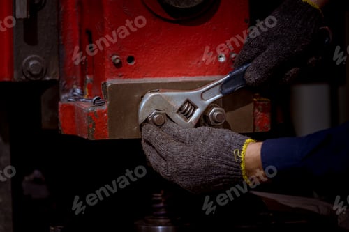 Preview: Engineer worker wearing safety uniform control operating computer controlled Lathe grinding machine