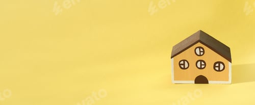Preview: wooden toy house on a yellow background. banner size, house rental and loan.