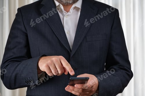 Preview: Confident Bearded Businessman in Black Suit Jacket Using Smartphone for Professional Networking