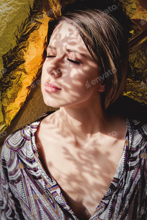 Preview: young woman in beautiful clothes with shadows on her face
