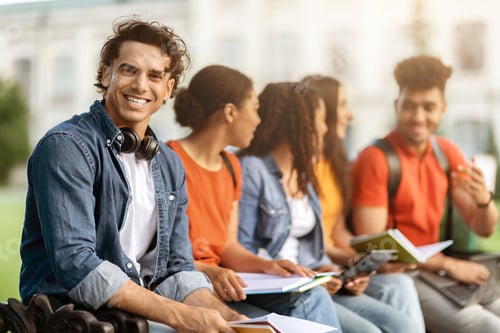 Preview: Study Together. Student Guy Preparing For Exams Outdoors With His University Friends