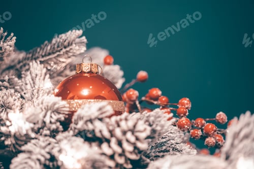 Preview: Christmas decorations with ball and fir branch in magic light.