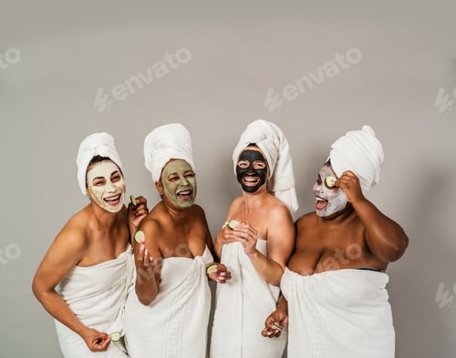 Preview: Happy multiracial women with different ages and body size having skin care spa day