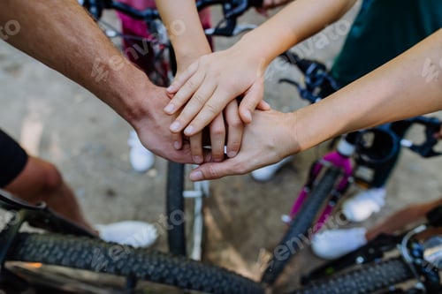 Preview: Top view of family holding hands together during bicycle trip, concept of cooperation.