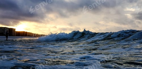 Preview: Rough sea in morning at golden hour with ocean waves hitting seascape.
