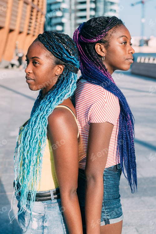 Preview: Two beautiful young black sisters outdoor back to back looking over