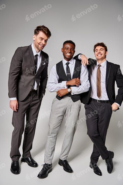 Preview: cheerful good looking multicultural friends in business casual outfits smiling and having great time