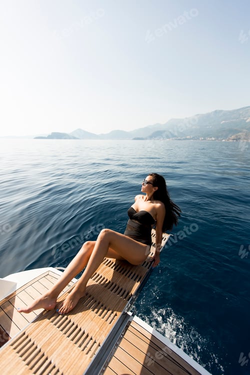 Preview: Woman Relaxes on Yacht Overlooking the Ocean