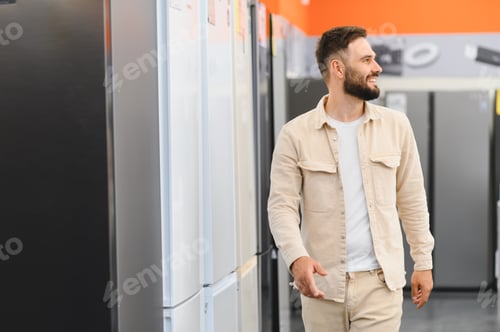 Preview: Customer choosing refrigerator in electronics store appliance department
