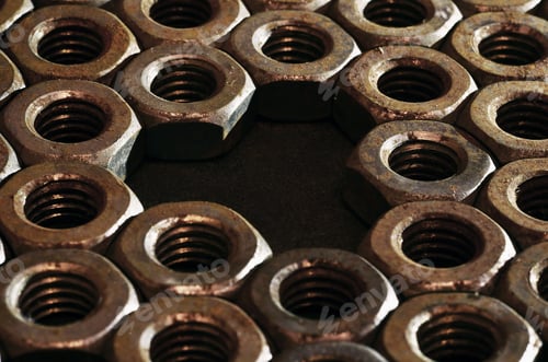 Preview: Closeup of a pile of rusty nuts. Retro industrial concept