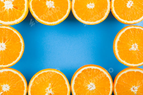 Preview: Cut Halves Of Juicy Orange On Blue Background. Orange Fruit, Citrus Minimal Concept. Creative
